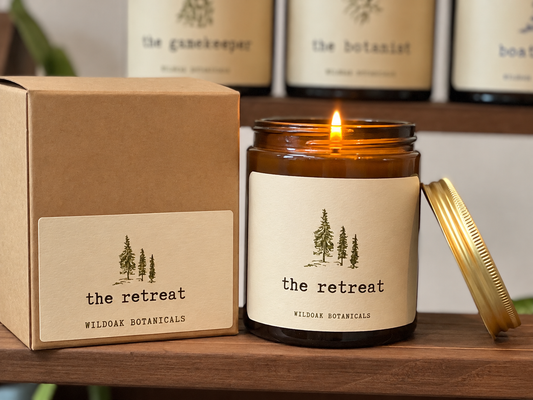 WILDOAK BOTANICALS THE RETREAT soy candle with pine, peppermint, and eucalyptus fragrances, featuring a natural wax container.