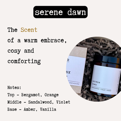 Soy candle in a glass jar with a wooden lid, labeled "Serene Dawn" by Cosyplace Candle Co., featuring warm amber and sandalwood scent.