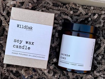 Serene Dawn Pet Friendly soy candle by Wildok Botanicals. with sandalwood and amber scent, shown in a glass jar with a cotton wick in eco friendly packaging