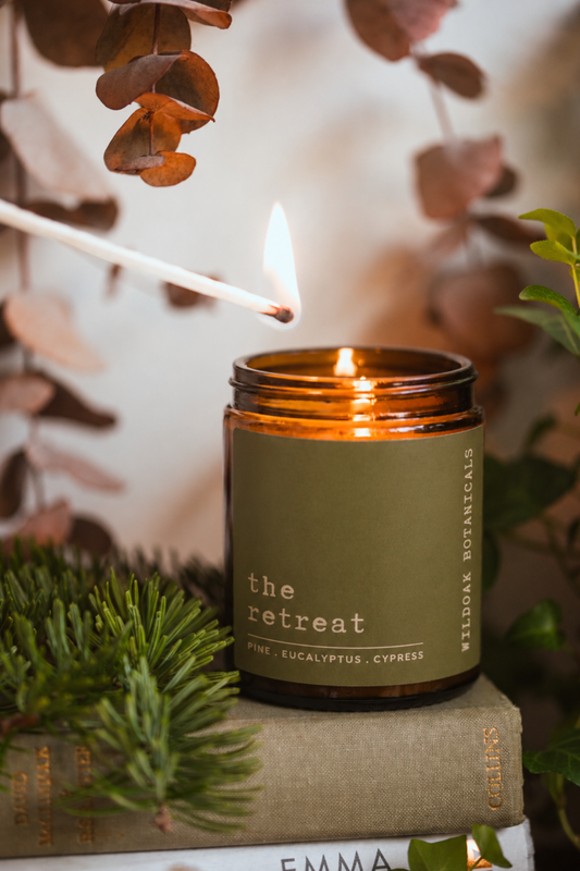 Soy candle from WILDOAK BOTANICALS with a pine, peppermint, and eucalyptus scent, featuring a sleek jar and minimalist apothecary label design.