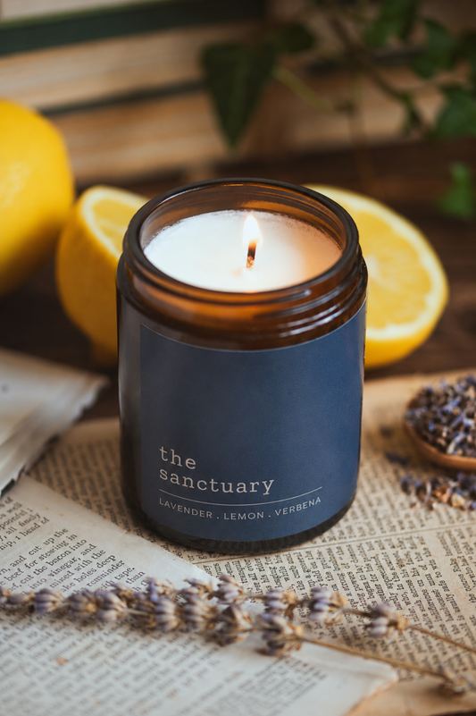 Soy candle from Wildoak Botanicals with lavender, lemon, and ylang ylang essential oils in aglass jar.n amber 